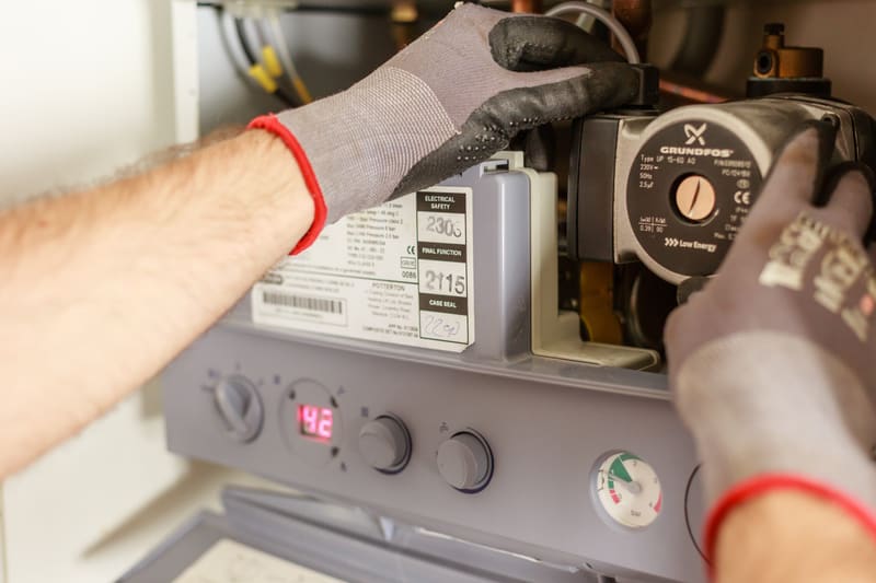Engineer checking a gas boiler during a service